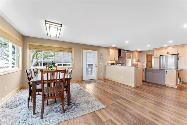 dining space featuring recessed lighting, baseboards, and light wood-type flooring