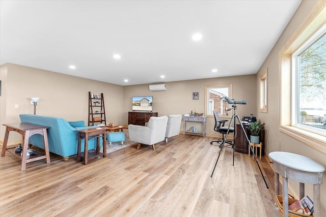 living room with recessed lighting, light wood-style floors, plenty of natural light, and a wall mounted air conditioner
