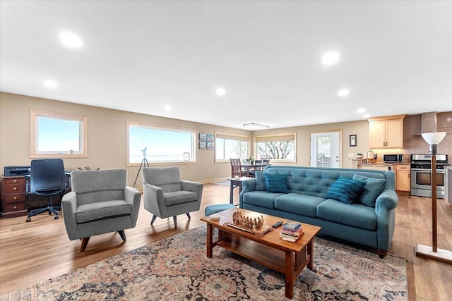 living room with recessed lighting and light wood-type flooring