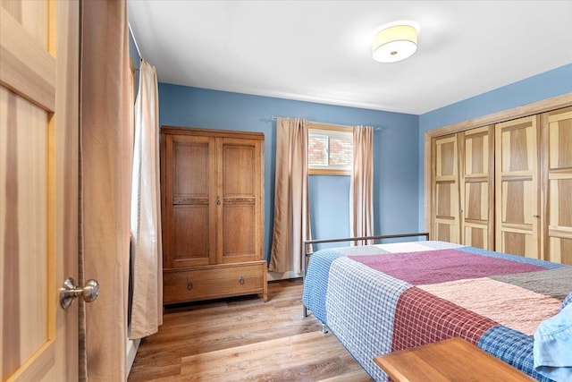 bedroom featuring a closet and light wood-style flooring