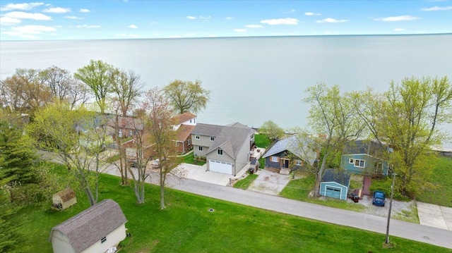 birds eye view of property featuring a water view and a residential view