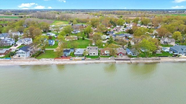 drone / aerial view featuring a residential view and a water view