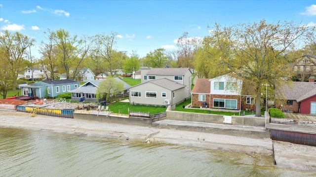 drone / aerial view with a water view and a residential view
