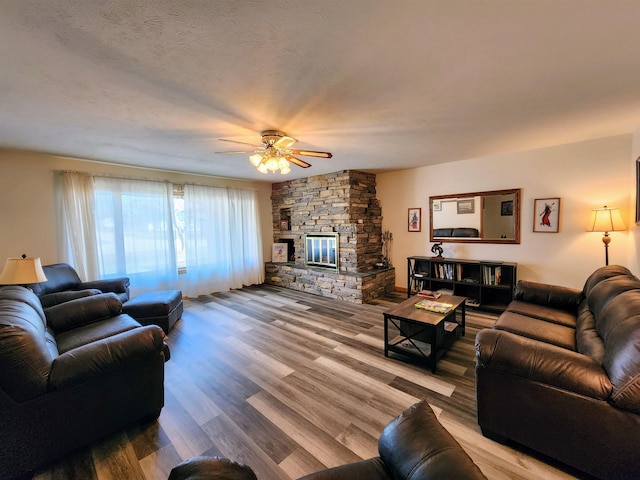 W11635 Lake St, Naubinway, MI 49762 - living area with ceiling fan, a stone fireplace, and wood finished floors