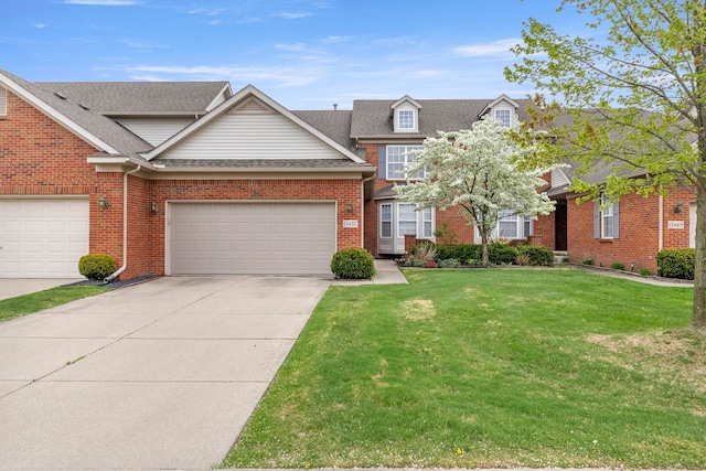 townhome / multi-family property with brick siding, a front lawn, roof with shingles, and driveway