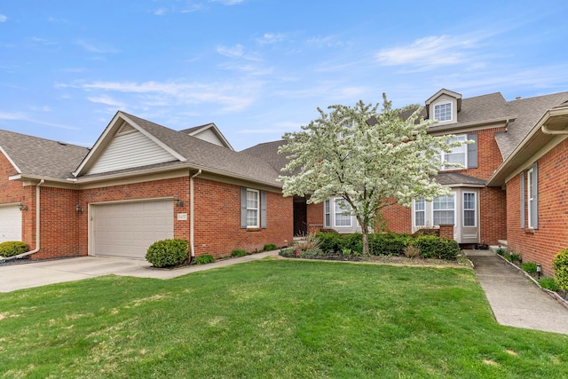 townhome / multi-family property with brick siding, a front lawn, concrete driveway, an attached garage, and a shingled roof
