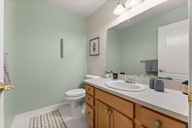 bathroom with vanity, tile patterned flooring, baseboards, and toilet