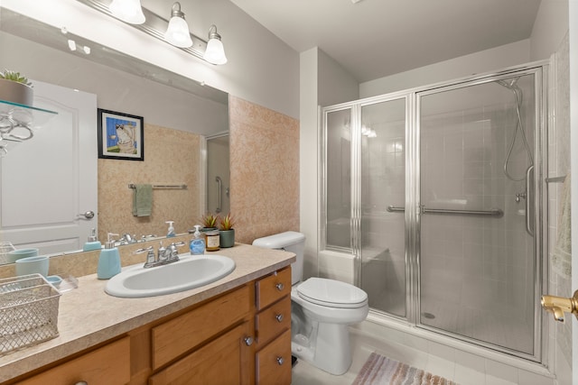 full bathroom with vanity, tile patterned flooring, a stall shower, and toilet