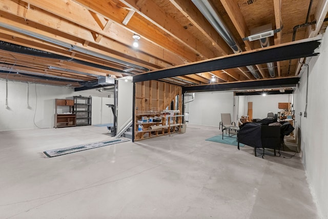 unfinished basement featuring visible vents and stairway
