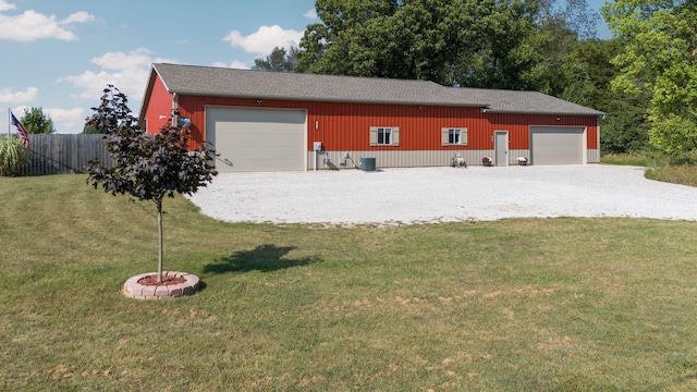 garage featuring central air condition unit and fence