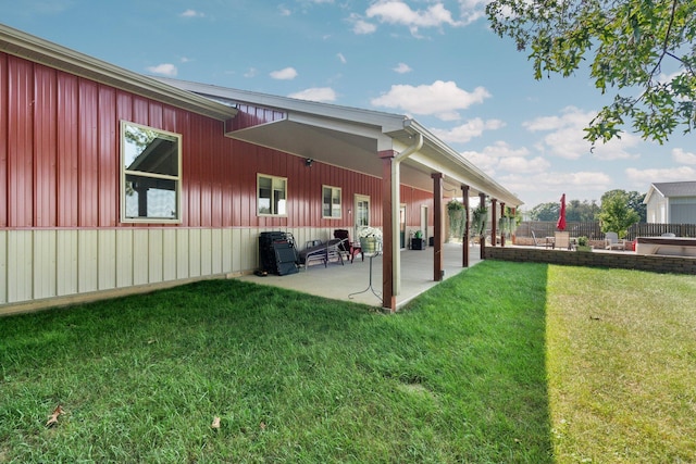 back of property featuring a patio area, fence, and a yard