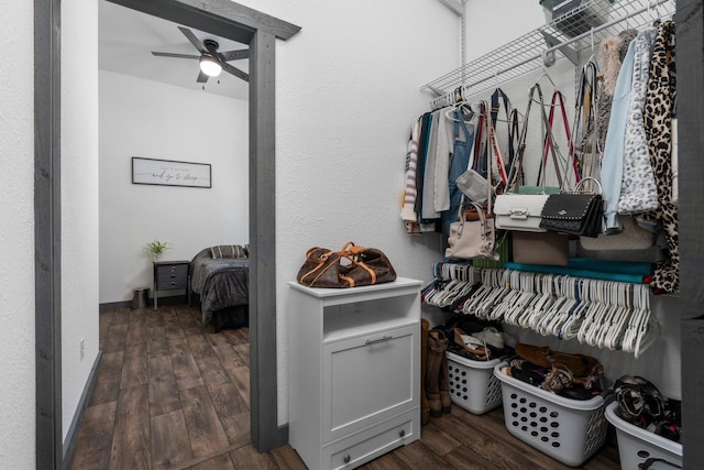 walk in closet featuring ceiling fan and wood finished floors