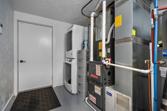 utility room featuring stacked washer / drying machine and heating unit
