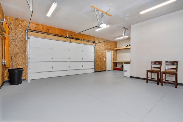 garage featuring baseboards and a garage door opener