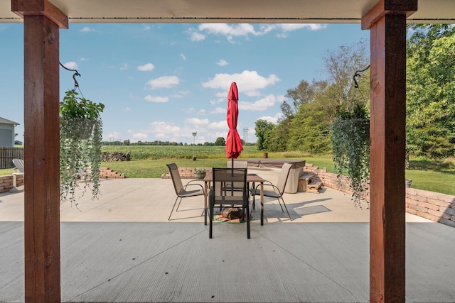 view of patio / terrace featuring a rural view and outdoor dining area