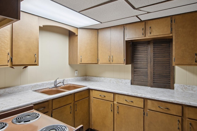 kitchen with a sink, light countertops, and electric range