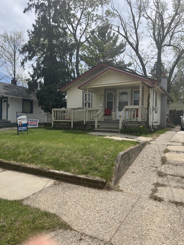 bungalow with a porch and a front yard