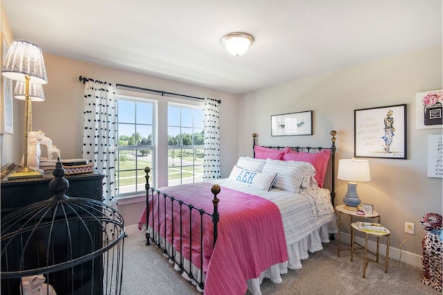 carpeted bedroom featuring baseboards