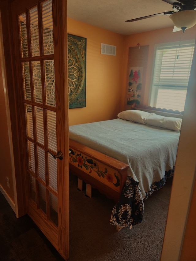 bedroom with ceiling fan and visible vents