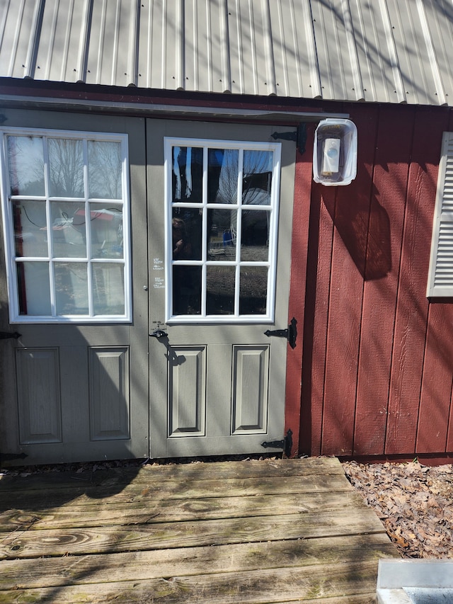 view of exterior entry with a deck