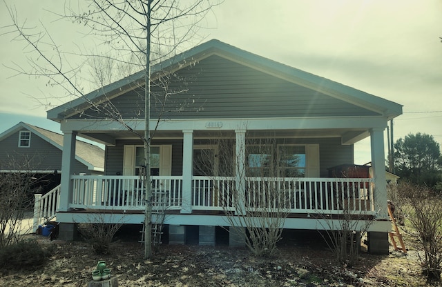 rear view of house with covered porch