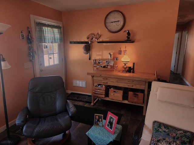 living area featuring baseboards and visible vents