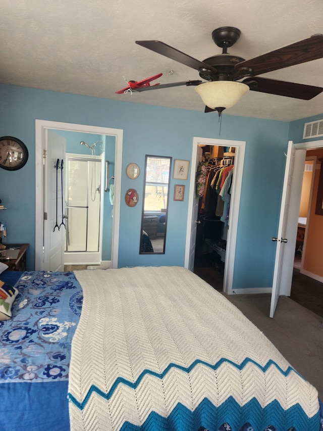 bedroom with a ceiling fan, visible vents, baseboards, a closet, and a spacious closet