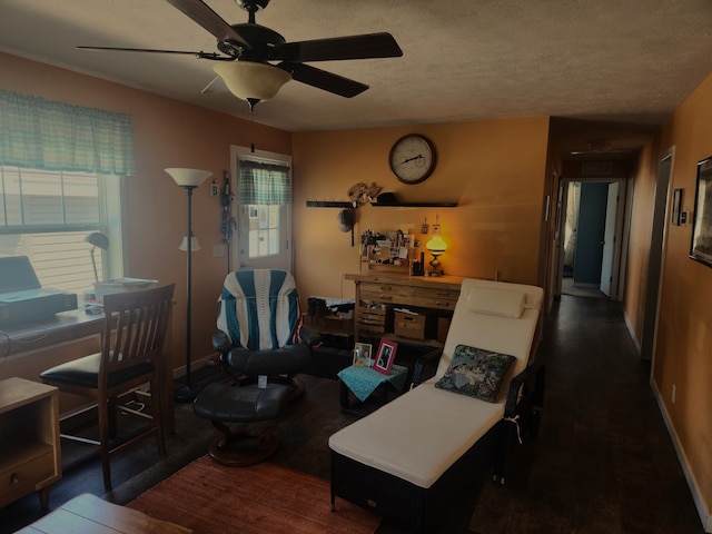 interior space with baseboards, a ceiling fan, and wood finished floors