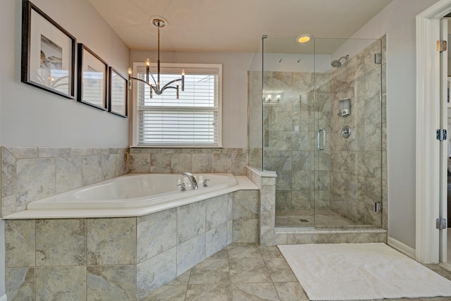 bathroom featuring a notable chandelier, a garden tub, and a stall shower