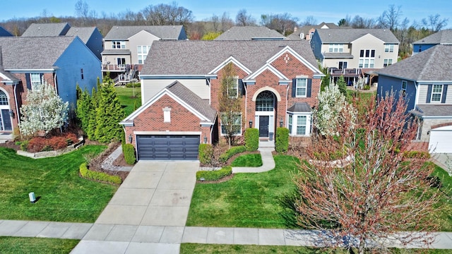 traditional-style house with brick siding, a front lawn, driveway, and a residential view