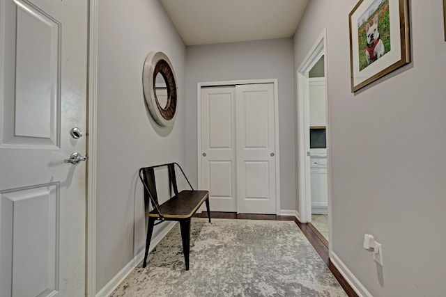 interior space with baseboards and wood finished floors