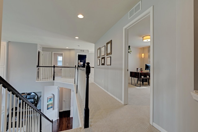 hall featuring carpet floors, recessed lighting, and visible vents