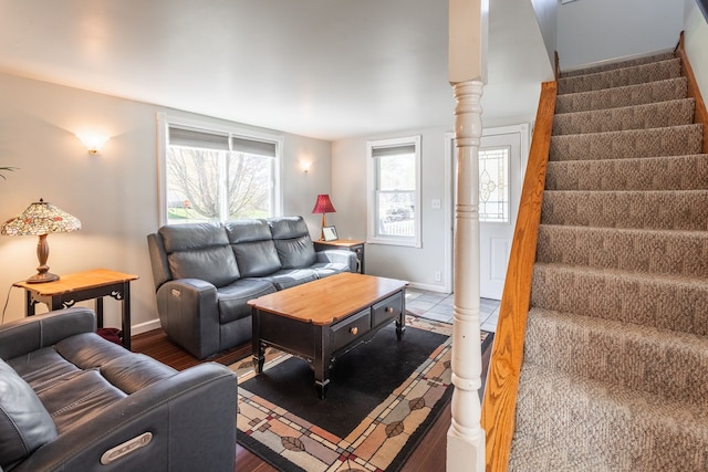 living room with baseboards, stairs, and wood finished floors