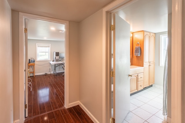hall featuring baseboards and wood finished floors