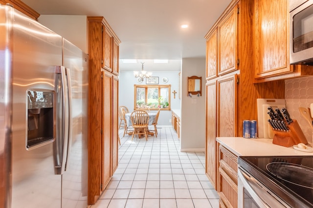 interior space with recessed lighting, an inviting chandelier, and light tile patterned floors