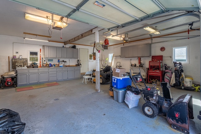 garage with a workshop area and a garage door opener