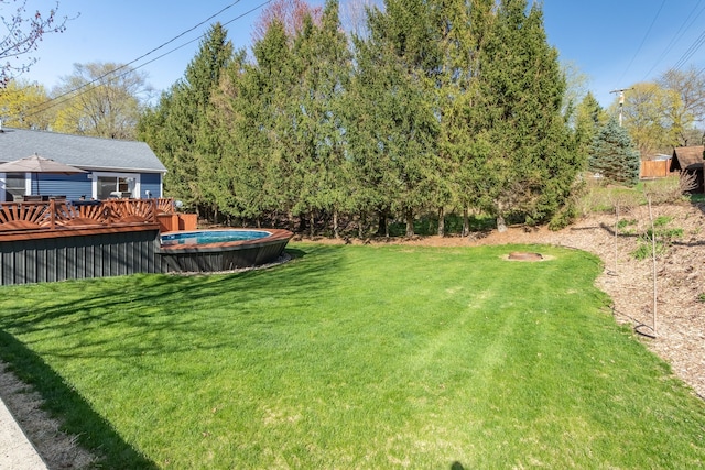 view of yard featuring a wooden deck and an outdoor pool