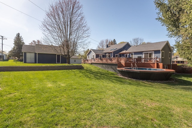 view of yard with a fenced in pool and a wooden deck