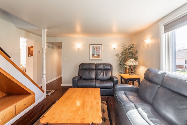 living area with visible vents, stairs, dark wood-style flooring, and baseboards