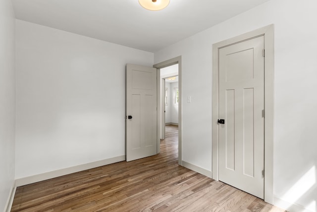 5857 Berkley Dr, Waterford, MI 48327 - unfurnished bedroom featuring light wood-style flooring and baseboards