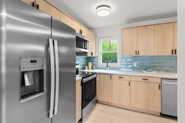 5857 Berkley Dr, Waterford, MI 48327 - kitchen with appliances with stainless steel finishes, light brown cabinetry, and light countertops
