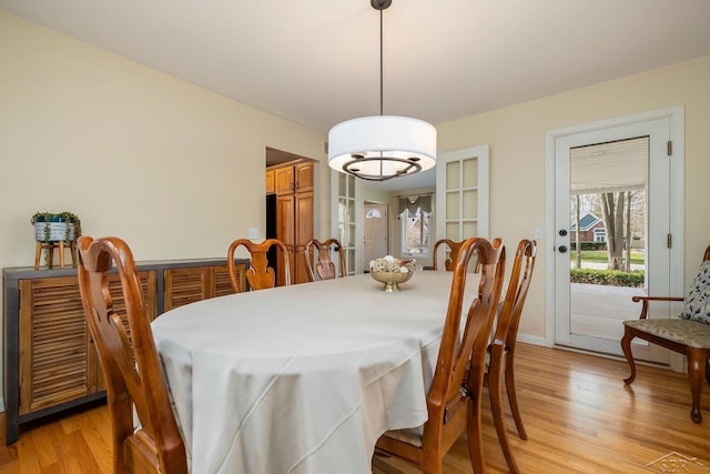 dining space with light wood-style flooring