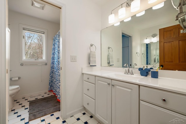 full bathroom with tile patterned floors, baseboards, vanity, and toilet