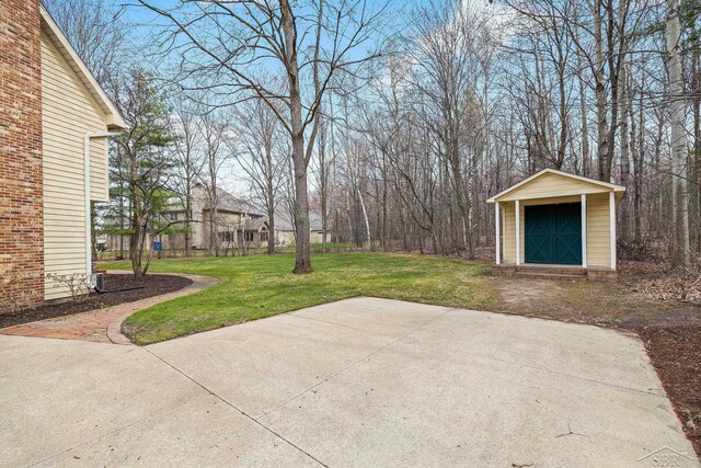 view of patio with an outbuilding and a storage unit