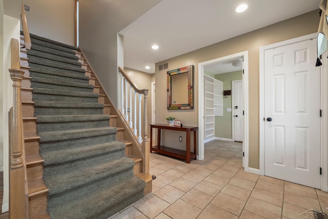 staircase with recessed lighting, baseboards, visible vents, and tile patterned flooring