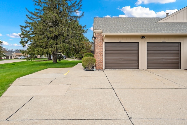 view of side of home with driveway, a lawn, a garage, brick siding, and a shingled roof