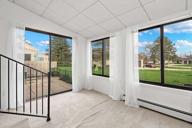 interior space with a baseboard heating unit and a wealth of natural light