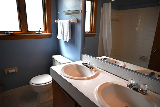 full bath with toilet, tile patterned floors, and a sink