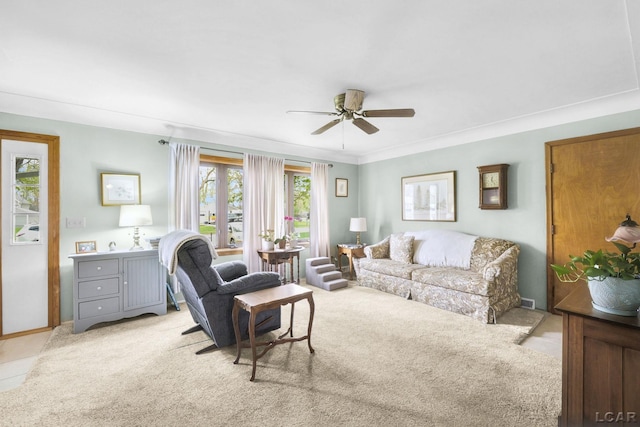 living area featuring a ceiling fan and light colored carpet