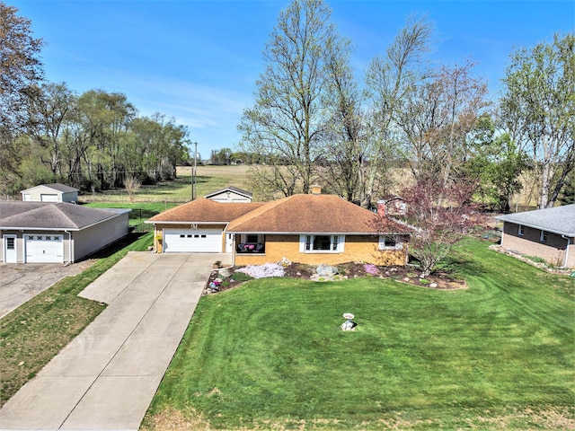 view of front of home featuring a garage, a front yard, and concrete driveway